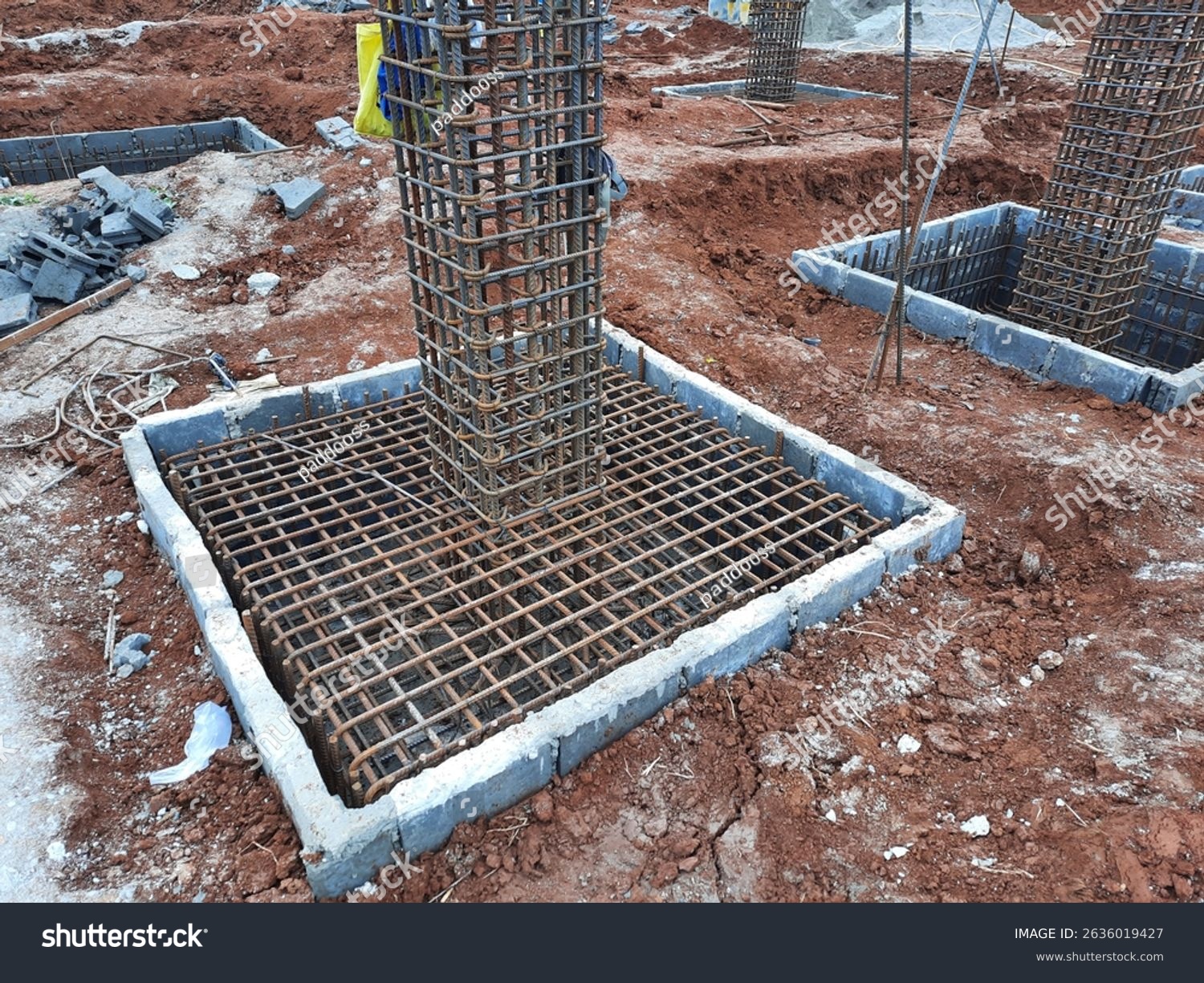 stock-photo-reinforced-concrete-footing-with-vertical-rebar-cage-prepared-for-column-construction-in-building-2636019427